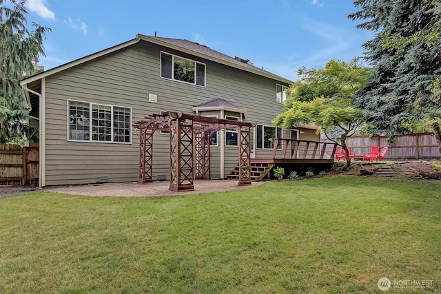 1125 Hemlock Ave SW, North Bend, WA 98045 - back of property with a fenced backyard, a deck, and a patio