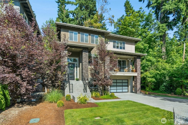 7223 NE 118th Ct, Kirkland, WA 98034 - view of front of house featuring driveway, stone siding, a garage, and a front yard
