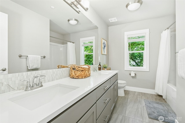 7223 NE 118th Ct, Kirkland, WA 98034 - bathroom featuring healthy amount of natural light, double vanity, shower / tub combo with curtain, and marble finish flooring