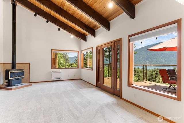 16537 Lakeview Dr, Leavenworth, WA 98826 - unfurnished living room with wooden ceiling, a wood stove, heating unit, and carpet flooring