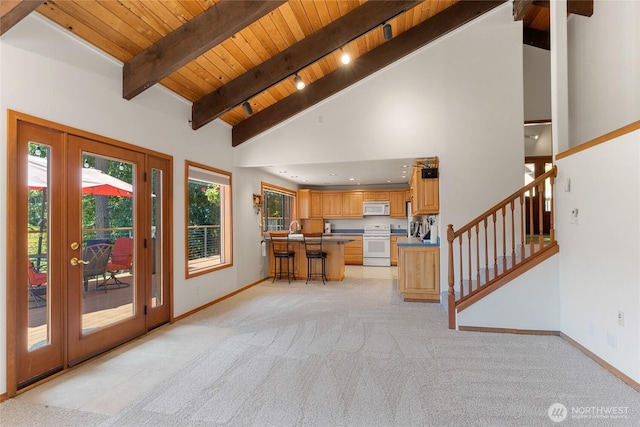 16537 Lakeview Dr, Leavenworth, WA 98826 - kitchen with white appliances, light carpet, a wooden ceiling with exposed beams, high vaulted ceiling, and a breakfast bar