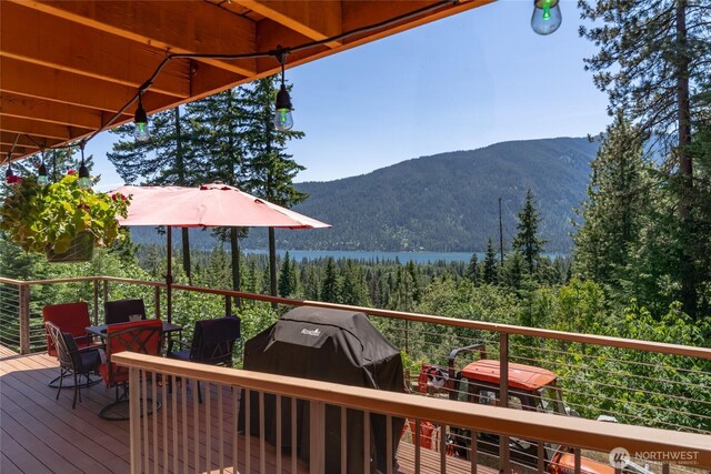 16537 Lakeview Dr, Leavenworth, WA 98826 - wooden deck with a grill, a mountain view, and a view of trees