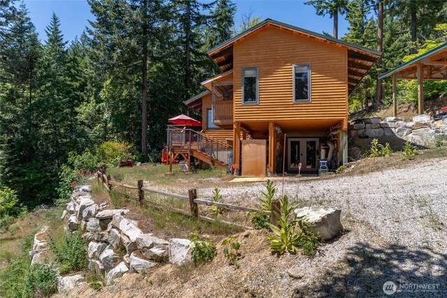16537 Lakeview Dr, Leavenworth, WA 98826 - rear view of house with french doors, stairs, driveway, and a wooden deck