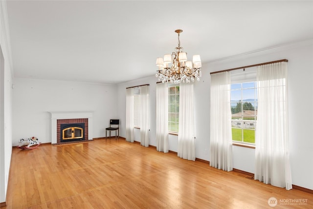 3505 Kimberly Ct, Wenatchee, WA 98801 - unfurnished living room with a chandelier, light wood finished floors, a fireplace, and ornamental molding