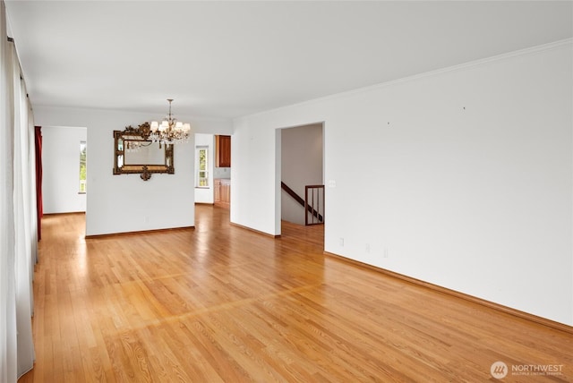 3505 Kimberly Ct, Wenatchee, WA 98801 - empty room featuring a chandelier, light wood-type flooring, and ornamental molding