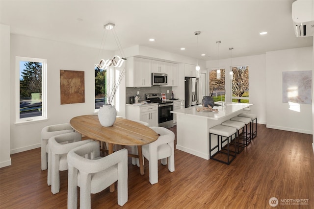 2749 Clare Ave Unit 1, Bremerton, WA 98310 - dining space with a wall mounted AC, dark wood-type flooring, plenty of natural light, and recessed lighting