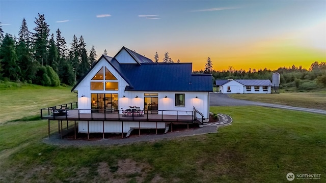 14045 Solberg Rd SE, Yelm, WA 98597 - rear view of house featuring a wooden deck, a yard, and a metal roof