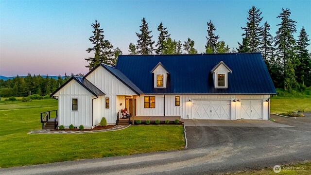 14045 Solberg Rd SE, Yelm, WA 98597 - modern farmhouse style home featuring a metal roof, board and batten siding, a garage, and dirt driveway