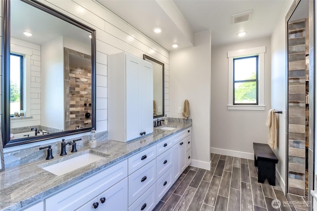 14045 Solberg Rd SE, Yelm, WA 98597 - full bathroom with double vanity, wood finished floors, and recessed lighting