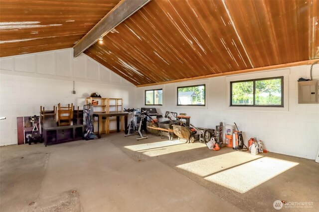 14045 Solberg Rd SE, Yelm, WA 98597 - garage featuring electric panel, wooden ceiling, and concrete block wall