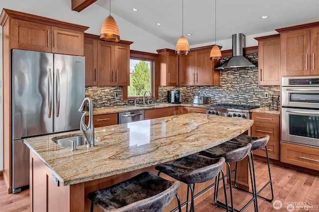 5829 112th Pl NE, Kirkland, WA 98033 - kitchen with stainless steel appliances, wall chimney range hood, light wood-style floors, light stone countertops, and brown cabinets