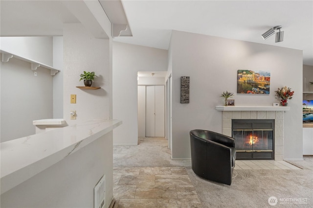 215 100th St SW Unit A305, Everett, WA 98204 - carpeted living room featuring a tiled fireplace