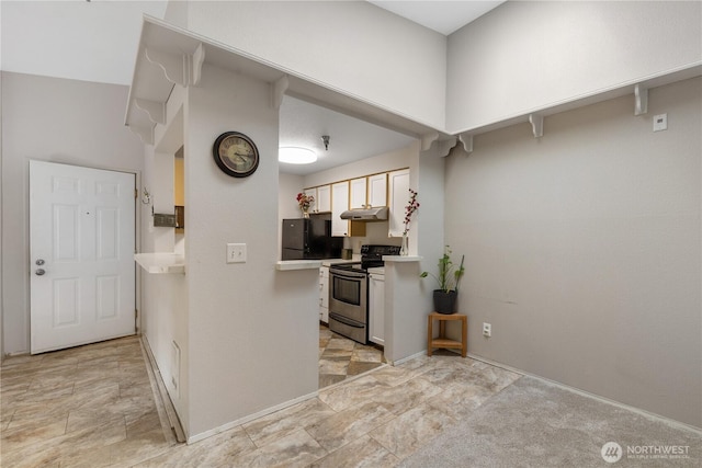 215 100th St SW Unit A305, Everett, WA 98204 - kitchen with stainless steel range with electric cooktop, freestanding refrigerator, under cabinet range hood, and light countertops