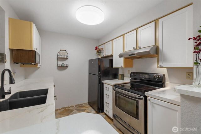 215 100th St SW Unit A305, Everett, WA 98204 - kitchen featuring stainless steel electric range oven, under cabinet range hood, freestanding refrigerator, and white cabinetry