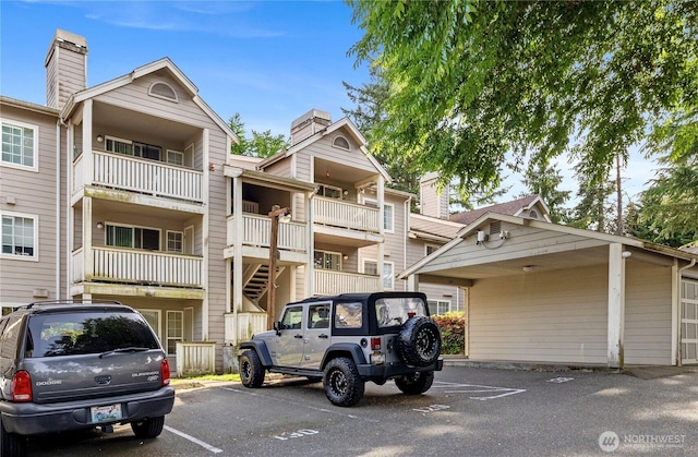 215 100th St SW Unit A305, Everett, WA 98204 - view of property featuring uncovered parking