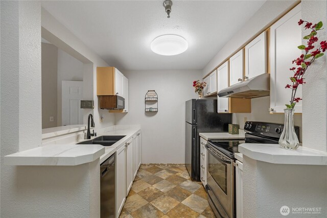 215 100th St SW Unit A305, Everett, WA 98204 - kitchen with under cabinet range hood, stainless steel appliances, stone finish floors, light countertops, and white cabinets