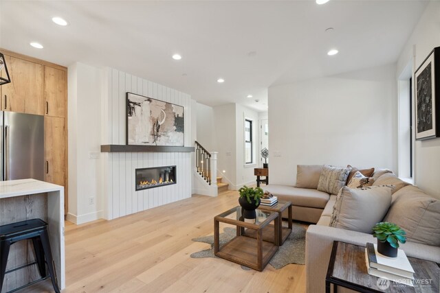 13005 NE 88th St, Kirkland, WA 98033 - living room with a glass covered fireplace, light wood-style flooring, recessed lighting, and stairway