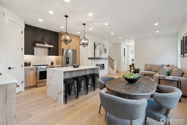 13005 NE 88th St, Kirkland, WA 98033 - dining area with recessed lighting, light wood finished floors, and stairway