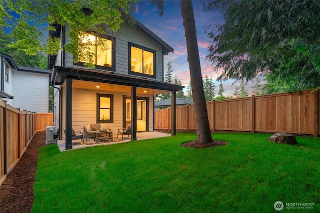 13005 NE 88th St, Kirkland, WA 98033 - back of property at dusk with outdoor lounge area, a fenced backyard, and a patio area