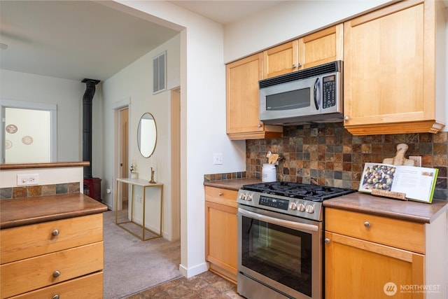 2226 King St, Bellingham, WA 98225 - kitchen featuring appliances with stainless steel finishes, dark countertops, tasteful backsplash, and light brown cabinetry