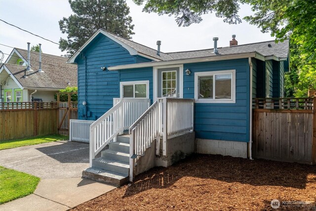 2226 King St, Bellingham, WA 98225 - view of front facade featuring a chimney, a shingled roof, and a patio
