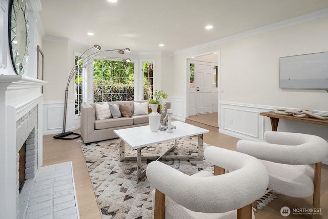 2892 160th Pl NE, Bellevue, WA 98008 - living room with wainscoting, a decorative wall, ornamental molding, a fireplace, and recessed lighting