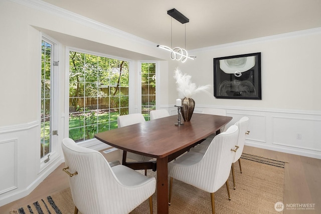2892 160th Pl NE, Bellevue, WA 98008 - dining room with a decorative wall, ornamental molding, wainscoting, and light wood finished floors