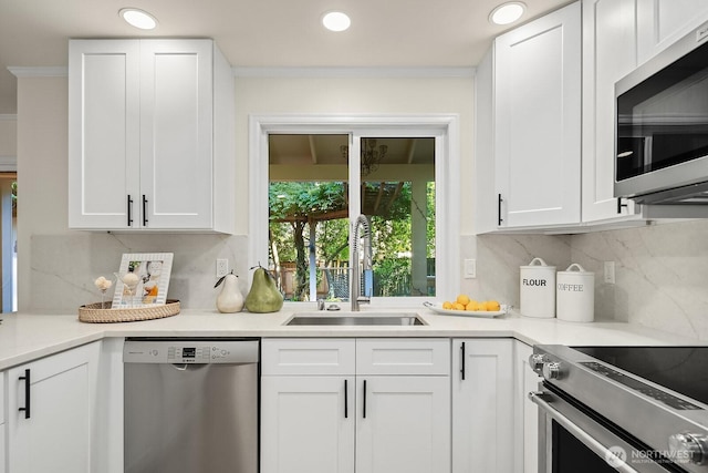 2892 160th Pl NE, Bellevue, WA 98008 - kitchen with appliances with stainless steel finishes, white cabinetry, decorative backsplash, light countertops, and crown molding