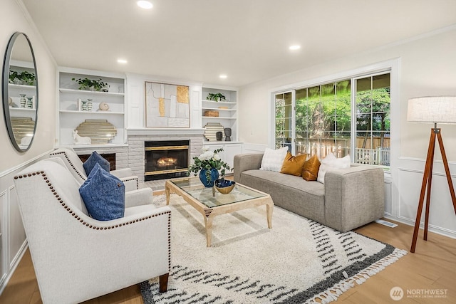 2892 160th Pl NE, Bellevue, WA 98008 - living area featuring wood finished floors, recessed lighting, a fireplace, crown molding, and built in shelves