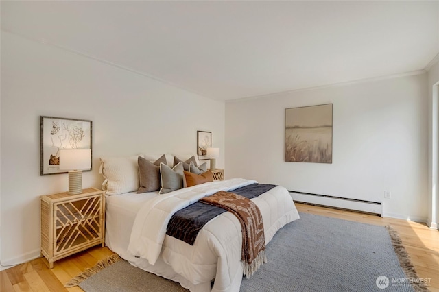 202 W Olympic Pl Unit 201, Seattle, WA 98119 - bedroom with a baseboard heating unit, light wood-style floors, and crown molding