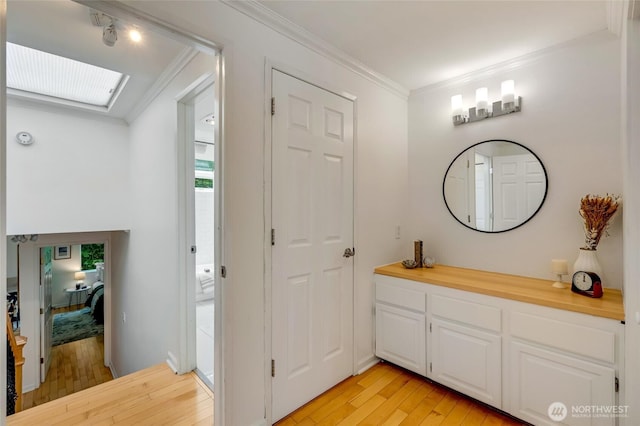 202 W Olympic Pl Unit 201, Seattle, WA 98119 - bathroom with wood-type flooring, crown molding, a skylight, and vanity