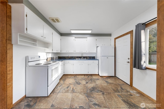 2104 E Ave, Anacortes, WA 98221 - kitchen featuring white appliances, dark countertops, white cabinets, dark stone finish floors, and open shelves