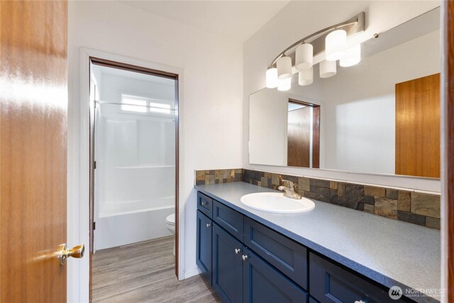 2104 E Ave, Anacortes, WA 98221 - bathroom with vanity, backsplash, wood finished floors, and shower / bathtub combination