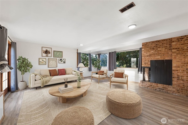 2104 E Ave, Anacortes, WA 98221 - living room featuring wood finished floors and a brick fireplace