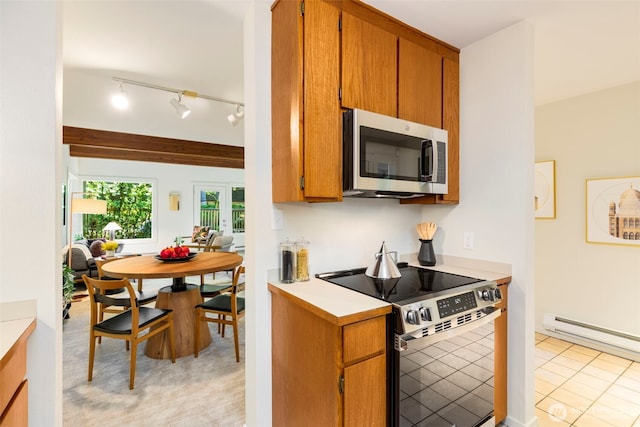 1717 16th Ave Unit 10, Seattle, WA 98122 - kitchen featuring stainless steel appliances, light countertops, brown cabinetry, and rail lighting