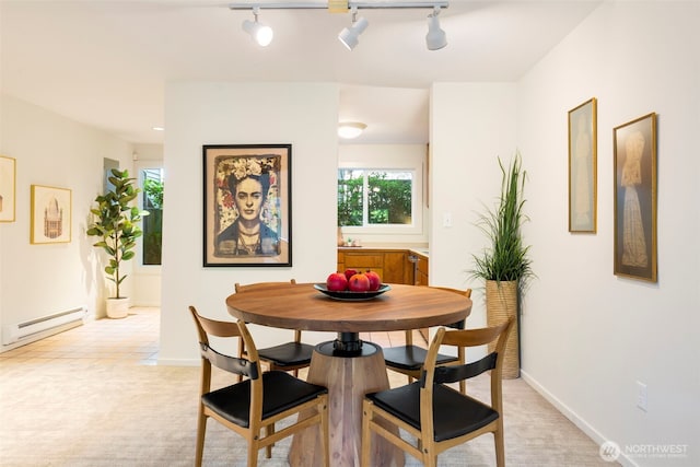 1717 16th Ave Unit 10, Seattle, WA 98122 - dining room with a baseboard radiator, rail lighting, and light carpet