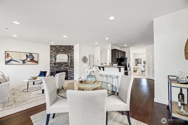 31 157th Ln SE, Bothell, WA 98012 - dining room with dark wood-type flooring, a fireplace, and recessed lighting
