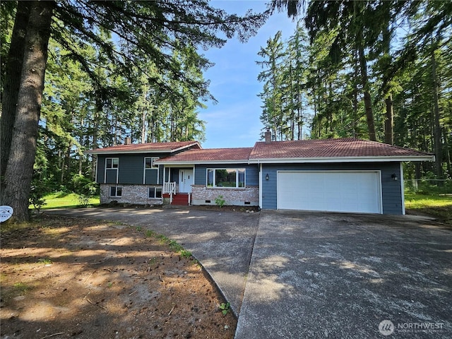 122 Fireweed St, Port Orchard, WA 98366 - tri-level home featuring concrete driveway, a garage, and a chimney