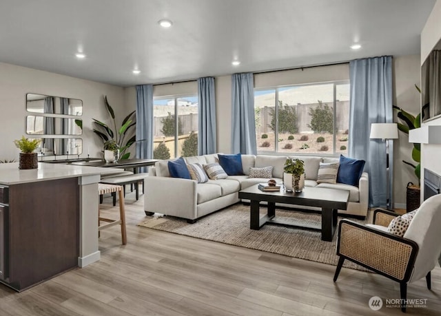 18527 135th Ave E Unit 127, Puyallup, WA 98374 - living room featuring light wood-style floors, recessed lighting, and a fireplace