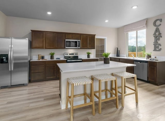 18527 135th Ave E Unit 127, Puyallup, WA 98374 - kitchen with stainless steel appliances, light countertops, light wood-type flooring, and recessed lighting