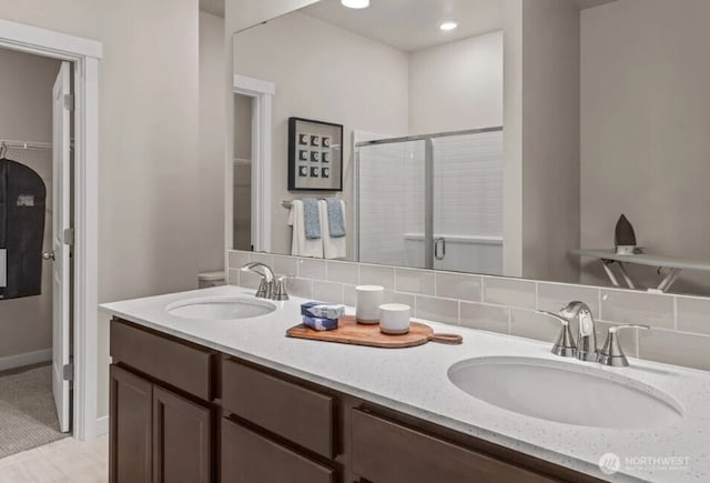 18527 135th Ave E Unit 127, Puyallup, WA 98374 - full bath with double vanity, a spacious closet, a stall shower, and tasteful backsplash