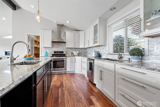 5530 Frances Ave NE, Tacoma, WA 98422 - kitchen with stainless steel appliances, wall chimney range hood, vaulted ceiling, white cabinets, and dark wood-style flooring