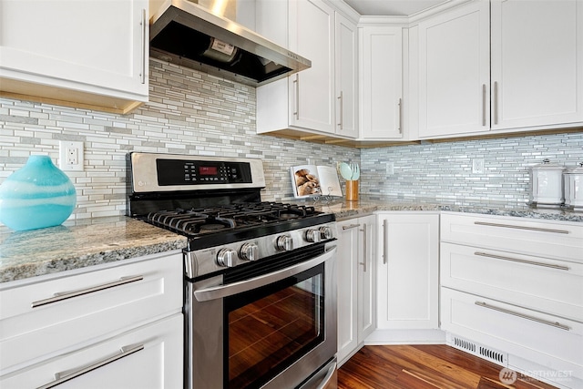 5530 Frances Ave NE, Tacoma, WA 98422 - kitchen featuring stainless steel gas range, wall chimney range hood, white cabinets, light stone countertops, and decorative backsplash