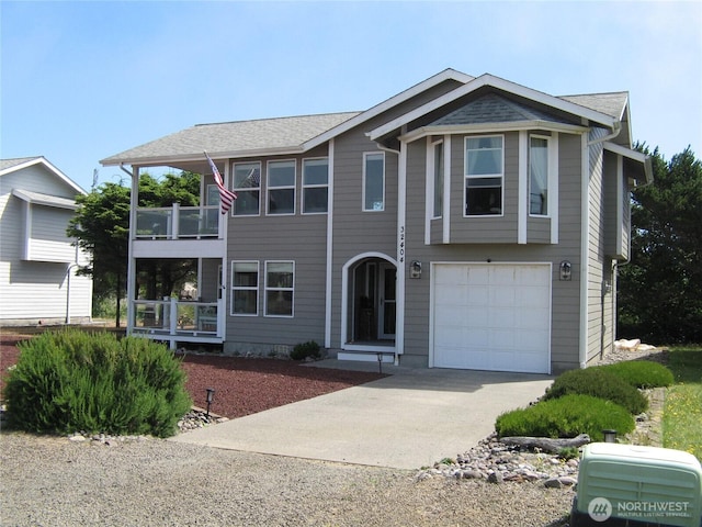 32404 G St, Ocean Park, WA 98640 - view of front facade featuring a balcony, driveway, and a garage