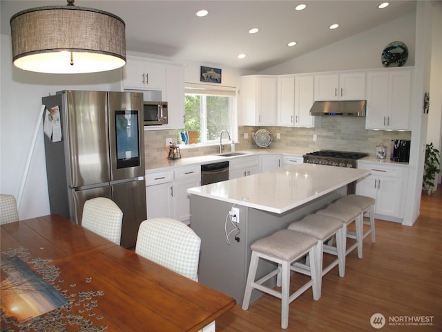 32404 G St, Ocean Park, WA 98640 - kitchen with stainless steel appliances, under cabinet range hood, recessed lighting, light wood-type flooring, and backsplash