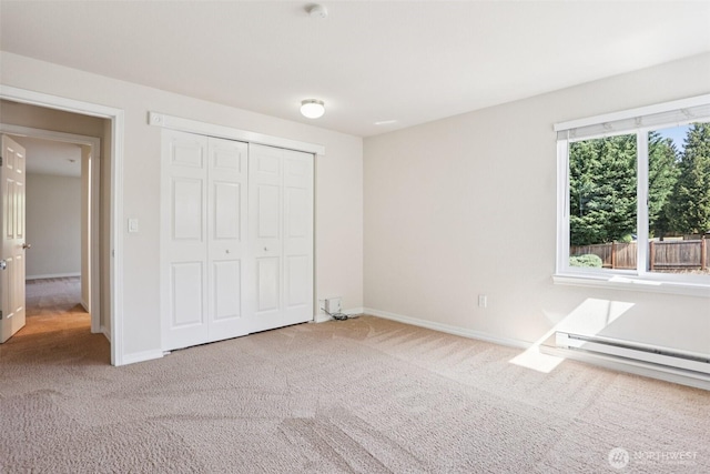 20320 Bothell Everett Hwy Unit D201, Bothell, WA 98012 - unfurnished bedroom with carpet floors, a baseboard heating unit, and a closet