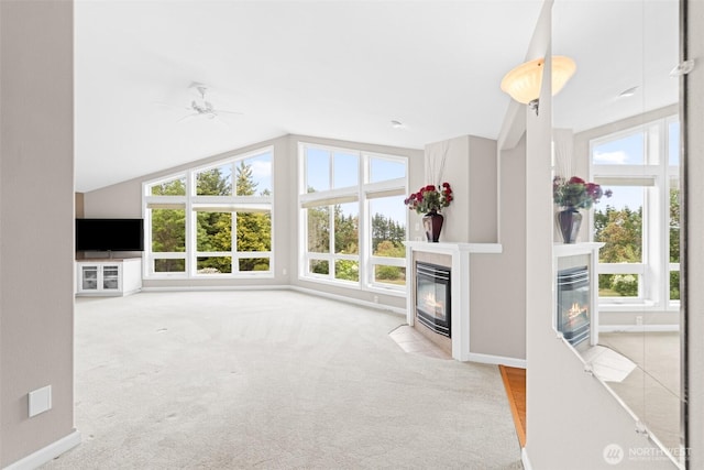 93 Old Schoolhouse Rd, Sequim, WA 98382 - unfurnished living room with a fireplace with flush hearth, healthy amount of natural light, lofted ceiling, and carpet flooring