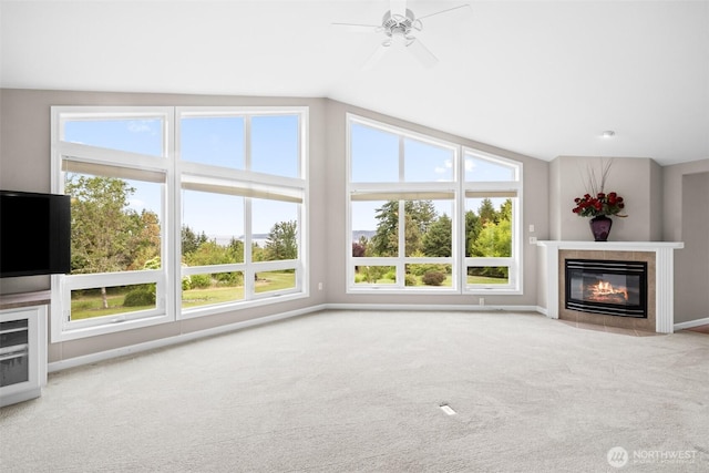93 Old Schoolhouse Rd, Sequim, WA 98382 - unfurnished living room with a tiled fireplace, carpet floors, ceiling fan, and vaulted ceiling