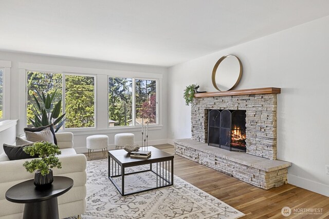 21240 15th Ave S, Des Moines, WA 98198 - living room featuring a lit fireplace and wood finished floors