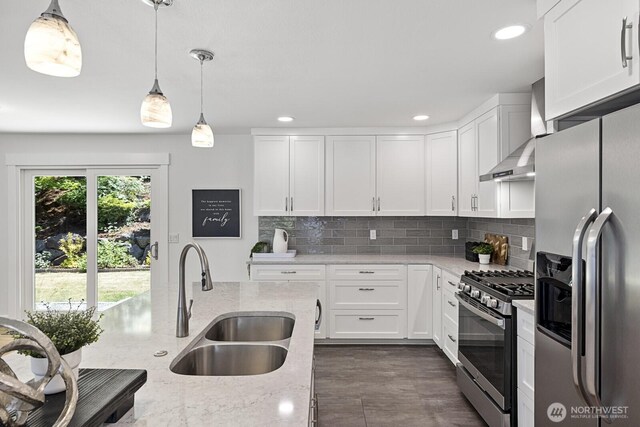 21240 15th Ave S, Des Moines, WA 98198 - kitchen featuring stainless steel appliances, wall chimney range hood, decorative backsplash, white cabinetry, and light stone counters